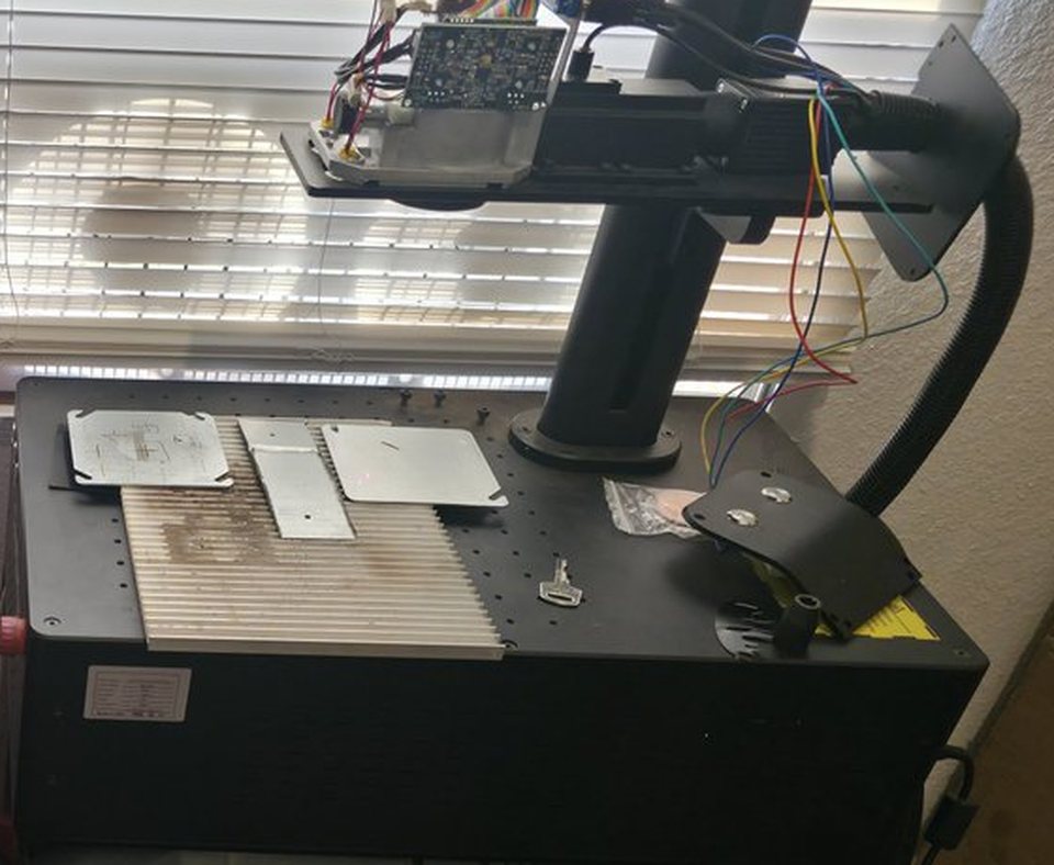Metal blanks on the bed of the fiber laser that engraves Capstrike slammers